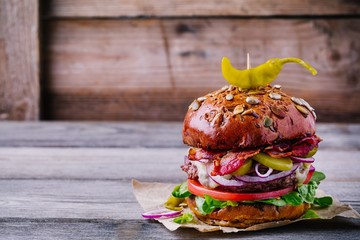 homemade burger with whole grain bun and fried bacon