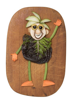 Vegetable gnome waves his hand on cutting board