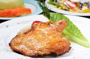 Boneless chicken leg on plate 