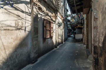 Narrow alley in old grunge dirty street in Yawarat road the China town of Bangkok Thailand