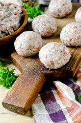 Raw meatballs on the chopping board