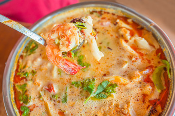 Tom Yum Koong  (Thai Language) is prawn and lemon grass soup with mushrooms the famous delicious Thai food.