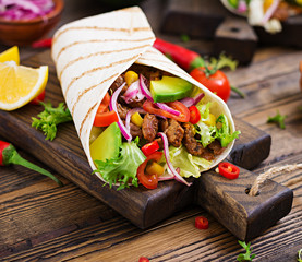 Mexican tacos with beef in tomato sauce and avocado salsa