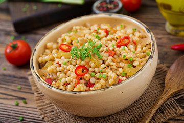 Vegetarian porridge from Turkish couscous with vegetables. Dietary menu. Vegan cuisine.