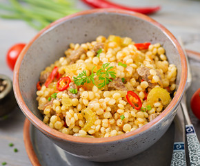 Porridge from Turkish couscous with beef and vegetables. Dietary menu.