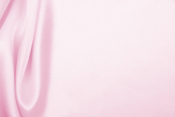 Obraz na płótnie Canvas Smooth elegant pink silk or satin texture as wedding background. Luxurious valentine day background design
