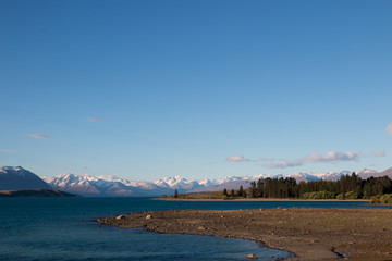 New Zealand Lake Tekapo blue lake with snow mountain range