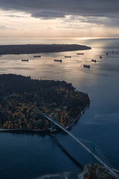 Lions Gate and Stanley Park Aerial during a vibrant colorful sunset. Taken in Vancouver, British Columbia, Canada.