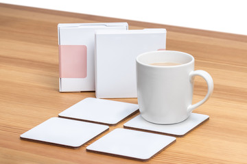 White cup of coffee with a blank white coasters.
