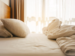 Fototapeta na wymiar Bed Mattress and Pillows Mess up Bedroom morning sunlight