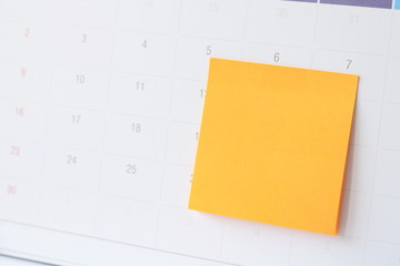 Paper notes on calendar at workplace with copy space for text,office supplies.