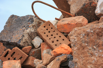 A pile of construction debris is broken brick and concrete.