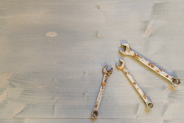 Different size wrenches on wooden background