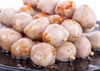 Grilled meat ball with sweet spicy sauce isolated on white.