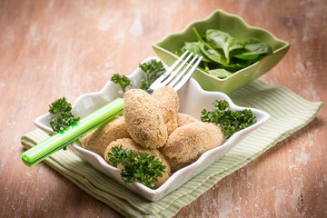 rice croquette with fresh spinac salad, selective focus