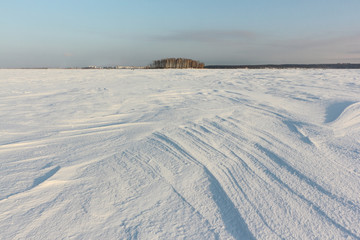 Relief snowy surface of the frozen river at dawn,  Ob River, Siberia, Russia