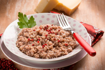 risotto with red wine red pepper and parmesan cheese, selective focus