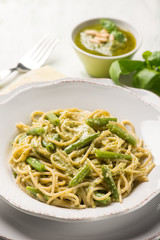 spaghetti with green beans and pesto sauce, selective focus