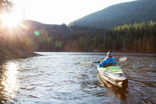 Girl Kayaking in a Lake. Taken in Buntzen Lake, Vancouver, British Columbia, Canada.