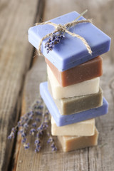 Assorted natural soap bars on wood