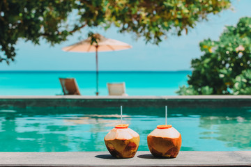 Fototapeta na wymiar two coconut drinks on tropical beach resort