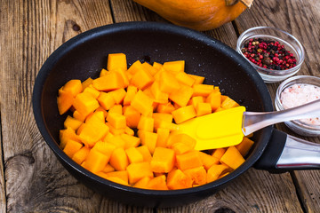 Pieces of pumpkin in frying pan