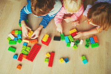 kids playing with plastic blocks, learning concept