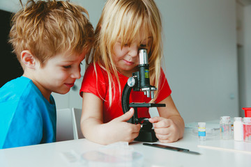 Kids learn to use microscope, science class, home learning concept