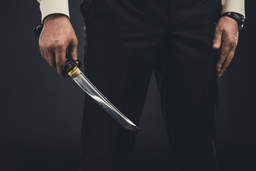 cropped shot of yakuza member with tanto knife