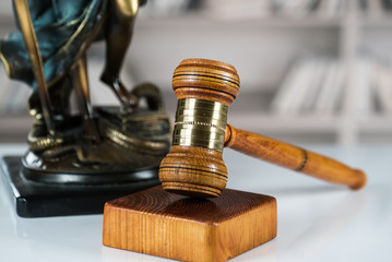 Law and Justice concept. Mallet of the judge, books, scales of justice. Gray stone background,...