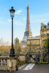 View of the Eiffel Tower from a small dead-end street of the Chaillot hill by a sunny winter...
