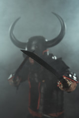 close-up shot of samurai in traditional armor with dual katana swords on dark background with smoke