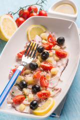 octopus salad with cherry tomatoes, selective focus
