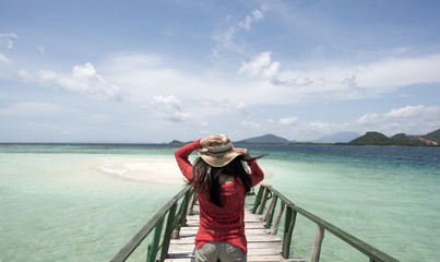 Young Woman Holding Hat at Beach