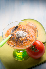 gazpacho with avocado tomato seeds poppy and cream sauce, selective focus