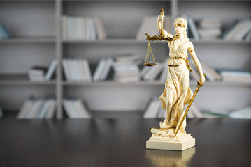 Obraz premium Law and Justice concept. Mallet of the judge, books, scales of justice. Gray stone background, reflections on the floor, place for typography. Courtroom theme.