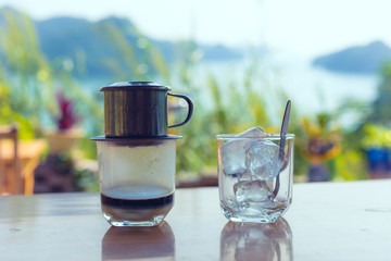 traditional Vietnamese coffee with landscape in background