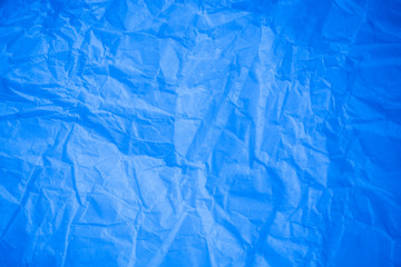 Crumpled blue paper background.