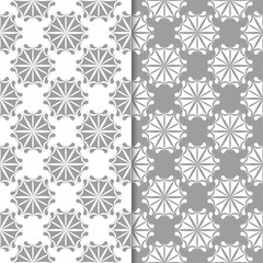 White and gray floral backgrounds. Set of seamless patterns