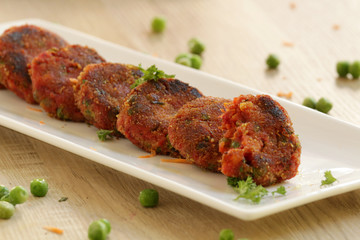 Vegetable cutlet or patties are a delicious snack made from boiled mixed vegetables. This can be eaten like that or kept inside a burger bun and served with tomato ketchup.
