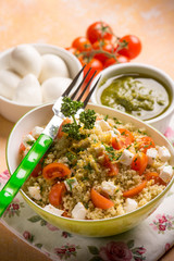 couscous with mozzarella tomatoes and pesto sauce, selective focus