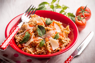 mafalda pasta with tomatoes mint , selective focus