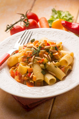 pasta with mixed vegetables and pine nuts, selective focus
