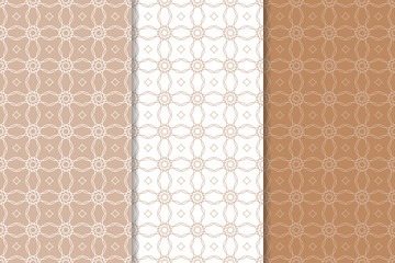 Brown and white geometric ornaments. Set of seamless patterns