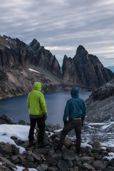 Fototapeta premium Couple adventurous friends are hiking in the wilderness on rocky mountain terrain. Taken Northeast of Seattle, Washington, United States of America. 