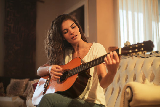 Beautiful woman playing the guitar
