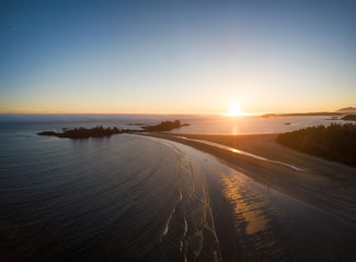 Aerial panoramic seascape view of the Beautiful Beach on Pacific Coast during a vibrant sunny summer sunset. Taken near Tofino, Vancouver Island, British Columbia, Canada.