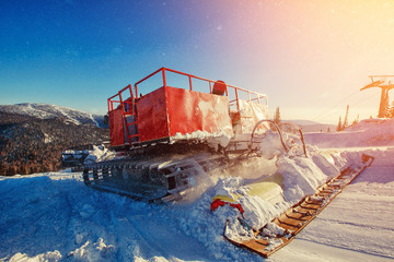 Snowcat trail bulldozer for skiers and snowboarders stands on background of mountains.Freeride snowboarding in Sheregesh ski resort