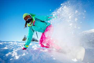 Snowboarder on snowboard rides through snow, explosion. Freeride snowboarding in Sheregesh Ski...