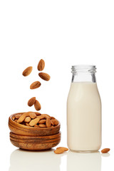 A glass of almond milk and a bowl of almonds